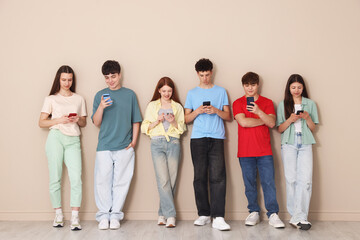 Obraz premium Group of teenagers with different smartphones indoors