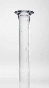 Laminar and turbulent flow of water transforming shapes with splashes and drops in slow motion and isolated on a white background, creating abstract transparent forms