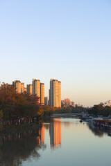 City Canal with Sunset Reflections and High-Rise Buildings © KieuLan