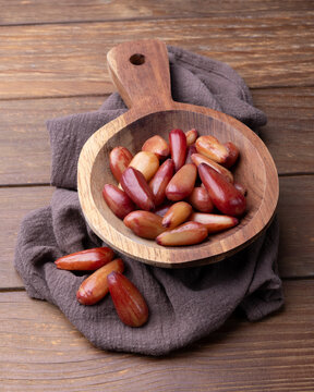 Cooked pinions or araucaria seeds on a bowl over wooden table