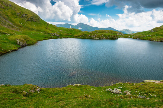 lake in romania mountain landscape. clear source of water. outdoor adventures in summer. cloudy sky over the fagaras ridge