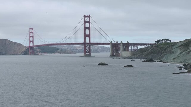 Golden Gate Bridge From Elevated Cliff Viewpoint On Overcast Day - Cinematic Aerial Shot