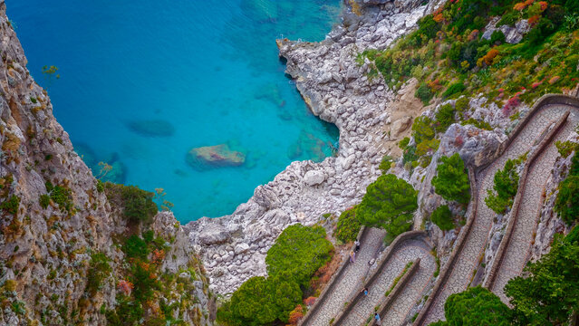Aerial drone view of Via Krupp winding stairs with breathtaking landscape on Capri Island, Italy, dramatic cliffs, turquoise sea and iconic Mediterranean coastal scenery