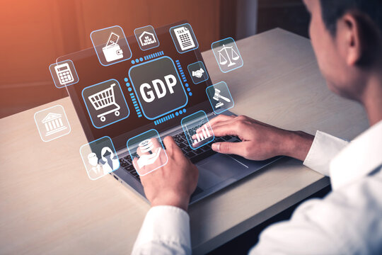 Business Professional Analyzing Economic Data on Laptop with Graphs and GDP Icons Representing Economic Indicators and Financial Information in Modern Office Setting Fluxor.