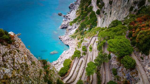 Aerial drone view of Via Krupp winding stairs with breathtaking landscape on Capri Island, Italy, dramatic cliffs, turquoise sea and iconic Mediterranean coastal scenery