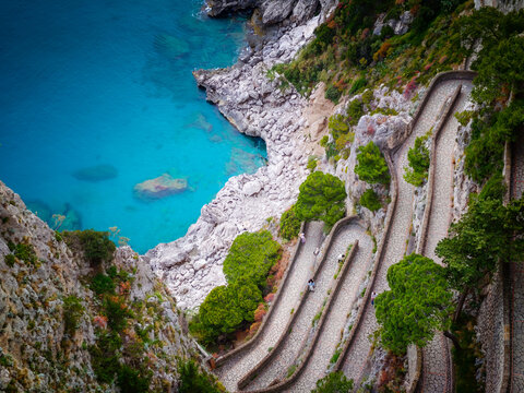 Aerial drone view of Via Krupp winding stairs with breathtaking landscape on Capri Island, Italy, dramatic cliffs, turquoise sea and iconic Mediterranean coastal scenery