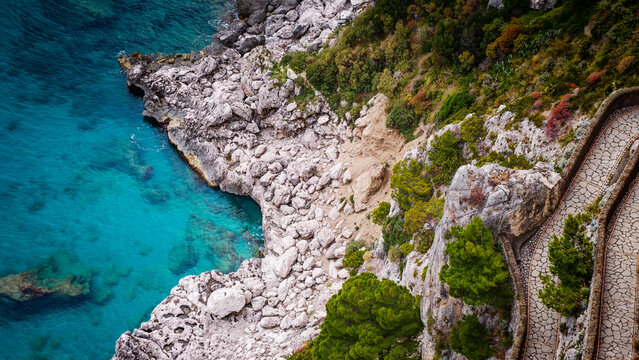 Aerial drone view of Via Krupp winding stairs with breathtaking landscape on Capri Island, Italy, dramatic cliffs, turquoise sea and iconic Mediterranean coastal scenery