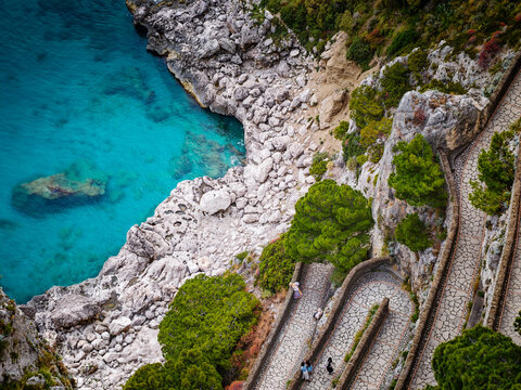 Aerial drone view of Via Krupp winding stairs with breathtaking landscape on Capri Island, Italy, dramatic cliffs, turquoise sea and iconic Mediterranean coastal scenery