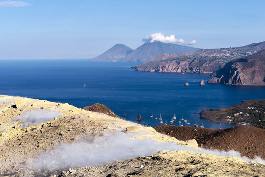 View from Vulcano island crater with smoking sulfur fumaroles looking towards Lipari and Salina Italy
