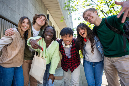 Excited Diverse Group of Students Posing Playfully Together on University Campus
