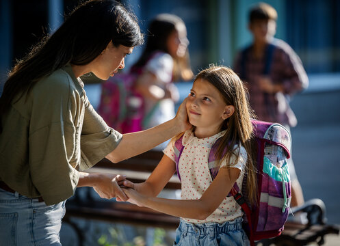 Child interacting with mother outside school
