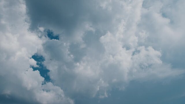 Timelapse of the cumulonimbus clouds running in the summer blue sky
