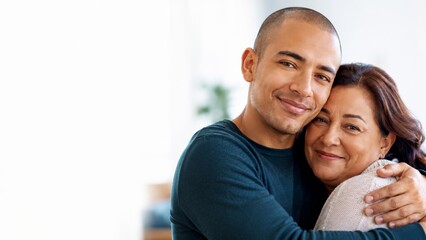 Obraz premium Happy mother and son embracing with genuine smiles, showcasing a strong family bond and affection