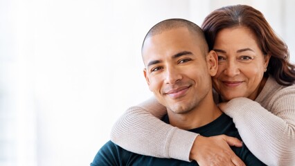 Fototapeta premium Happy mother and son embracing with genuine smiles, showcasing a strong family bond and affection