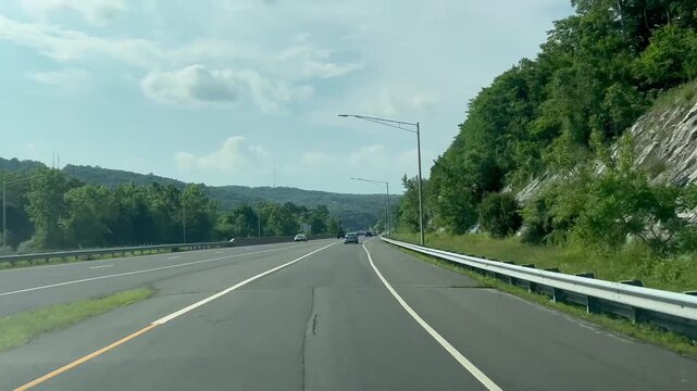 Driving on a highway with cars and scenic mountain view