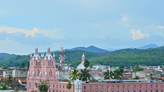 Guadalajara de Buga Cathedral Time Lapse Overlooking Tropical Town With Mountains and Palm Trees