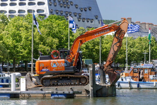 Nancy, France - June 13th 2026 : View on an orange crawler excavator Hitachi ZX160LC-6 on a barge for dredging work in the port of Nancy along the Marne-Rhine Canal.
