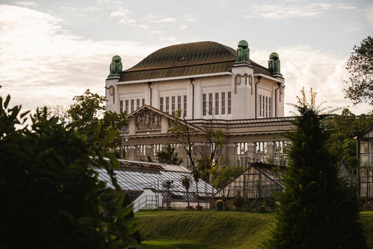 Beautiful owl statues made from cooper, standing on the rooftop of croatian state Archives building observed from the Botanical garden in the Zagreb city,  Croatia