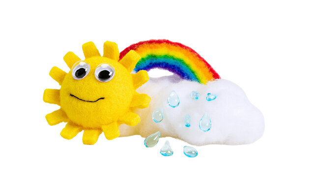 Felt sun with googly eyes and rainbow over fluffy cloud, isolated on transparent background