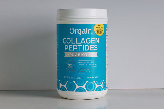 Orgain brand collagen peptides probiotics supplement on a white background with copy space