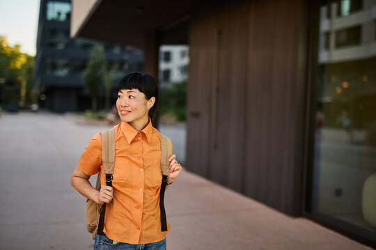 Young asian woman walking down the street or a tourist sightseeing