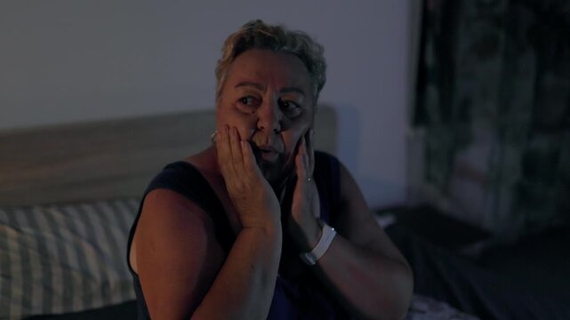 Overweight Shocked Mature Woman Looking Around Bedroom After Nightmare At Night