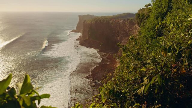 Slow Motion View Of Karang Boma Cliff And Rolling Ocean Waves During Golden Hour, Coastal Beauty And Travel Destination