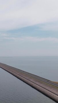 Aerial view of cars driving on the afsluitdijk dike in the netherlands