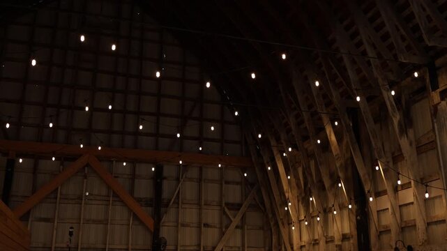Warm string lights in rustic barn interior