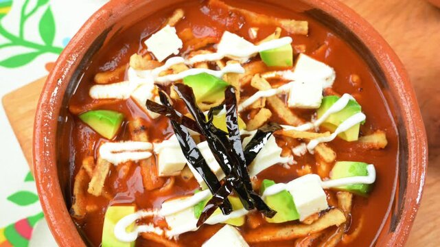 Sopa de tortilla, traditional Mexican dish with crispy tortilla strips and pasilla chili