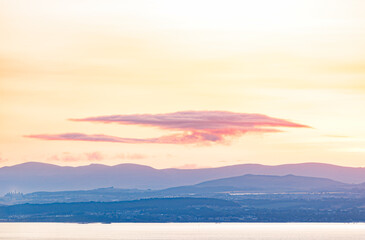 Fototapeta premium Sunset over mountains, calm water landscape, Scottish Highlands