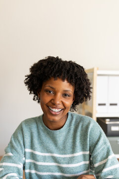 Happy young woman smiling while working from home