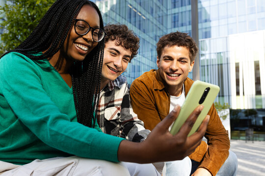 Group of students taking a selfie with a smartphone in university campus
