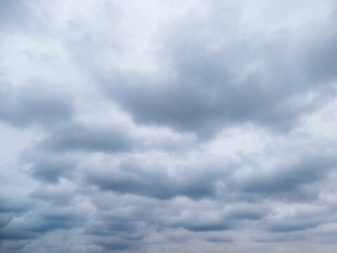 A cloudy sky filled with gray clouds creating a moody atmosphere, suitable for backgrounds in weather-related content and artistic photography.