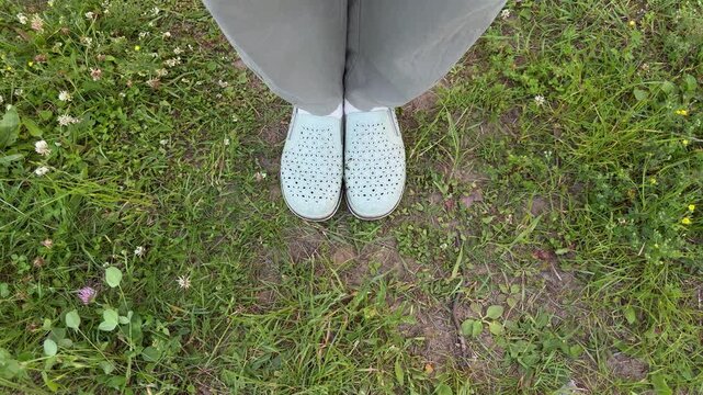 Close-up of casual slip-on shoes on green meadow, summer footwear for outdoor recreation and outdoor lifestyle