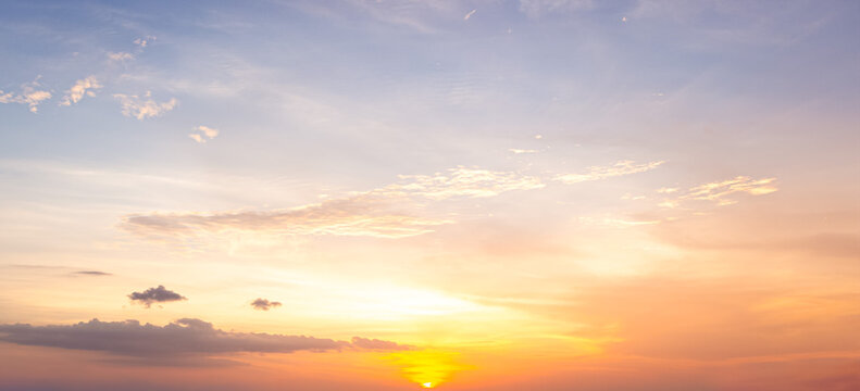 Beautiful sunset sky background with soft pastel orange light and bright golden sun glow for panoramic travel mockup design