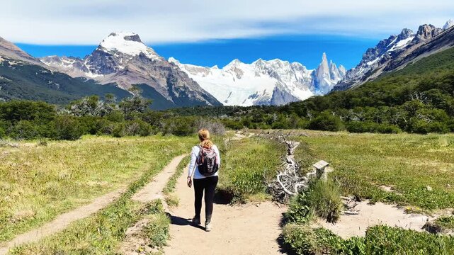 A female tourist is walking along the Laguna Torre hiking trail near El Chalten, Argentina