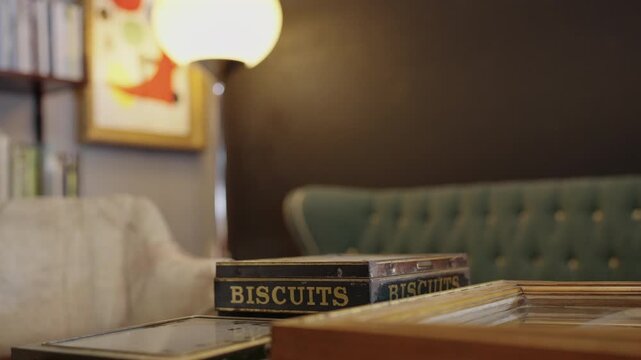 Vintage and Retro interior with furnitures: focus on a old biscuit box with blur background [180&deg; shutter angle n&deg; 10/10 Series 35mm and 22mm ] from 10 bits ProRes 442 - Slog 3 and Sony GM & G