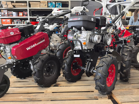 Compact farm machinery displayed in a workshop during daytime