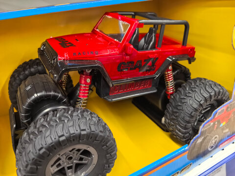 Bright red remote control car ready for adventure on rugged terrain