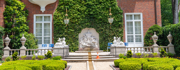 Obraz premium Historic Hillwood Estate Museum And Gardens Mansion Surrounded By Formal Courtyard And Landscape Architecture Features