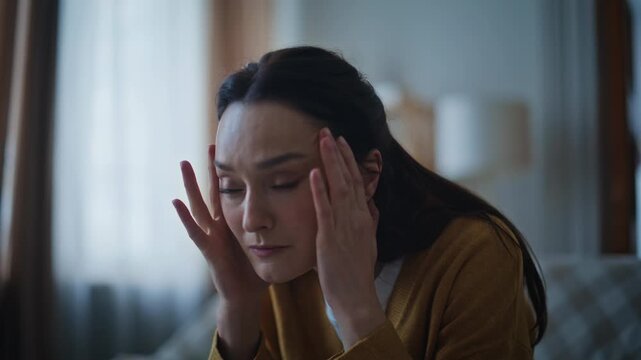 Closeup sad lady thinking life challenges sitting evening apartment alone