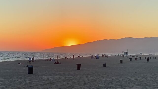 Slow motion of the orange sunset on the beach
