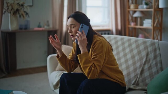 Lady complaining phone conversation on apartment sofa closeup. Stressed woman