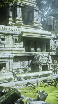 Ancient temple ruins are seen in a jungle setting. Moss covers the stones and fallen debris is scattered around. Light filters through the trees onto the structure.