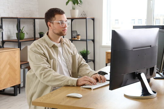 Portrait of focused male programmer working in office