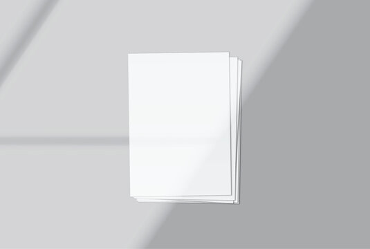 Blank white A4 paper sheets mockup on background with elegant organic shadow overlay. Perfect for displaying stationery designs, flyers, posters, branding, Ads and print design presentations
