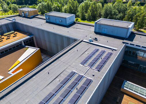 Aerial view of Morasko Campus featuring modern building rooftops with solar panel arrays and green surroundings in Poznan, Greater Poland Voivod, Poland.