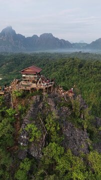 Vang Vieng, Laos - 07-02-2025: Aerial drone footage of the famous Nam Xay Viewpoint at the top of a limestone mountain in Laos, one of the famous karst landscape area in Southeast Asia.
