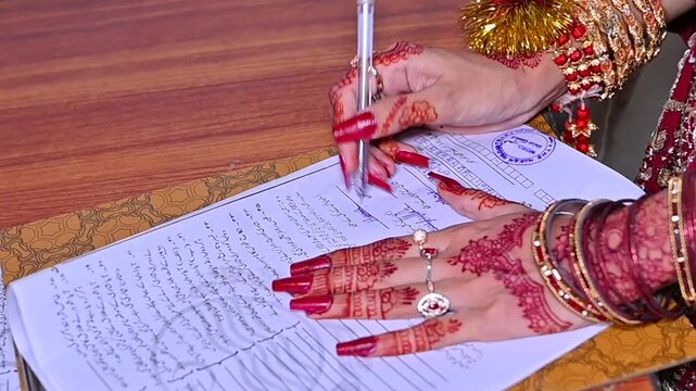 The bride signaturing on nikkah documents ( Muslims Ceremony )
